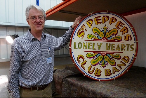 Photograph of Matthew H Goldsmith, Picture Restorer & Director, Trade Paintings Service Ltd, with restored Sgt. Peppers Lonely Hearts Club Band drum.